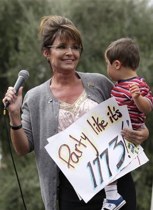 Former GOP vice presidential candidate Sarah Palin was the surprise guest at a Tea Party Express rally that drew about 1,000 people at the Arizona Capitol Friday, Oct. 22, 2010, in Phoenix.  Palin spoke for only a couple minutes on a stage as she held son Trig Palin on one hip and clutched a sign that read 